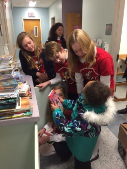 a little girl selects one of our donated books at the hospital